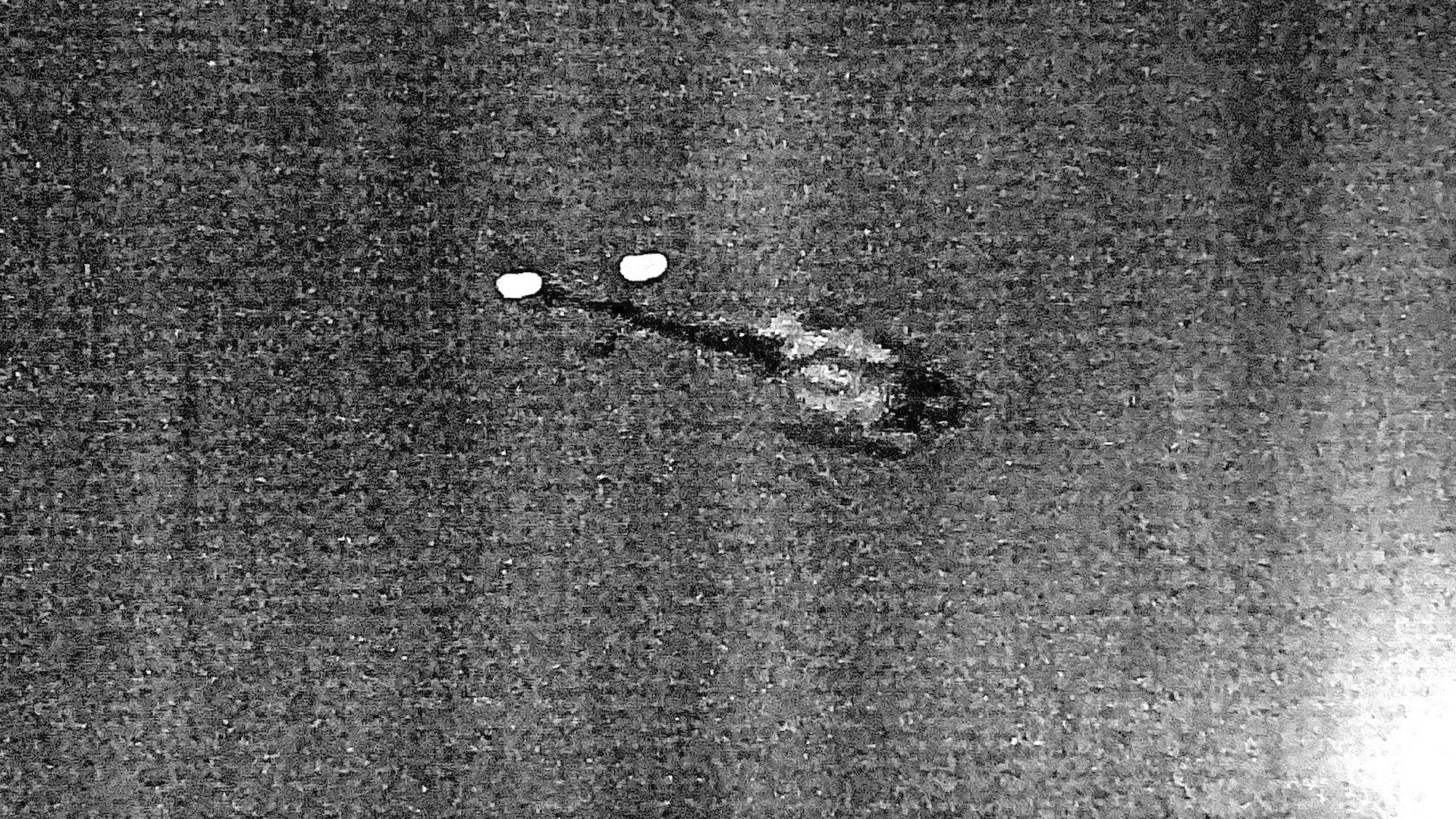 A black-and-white distorted image bearing marks of multiple photocopy passages, featuring what appears to be a helicopter
